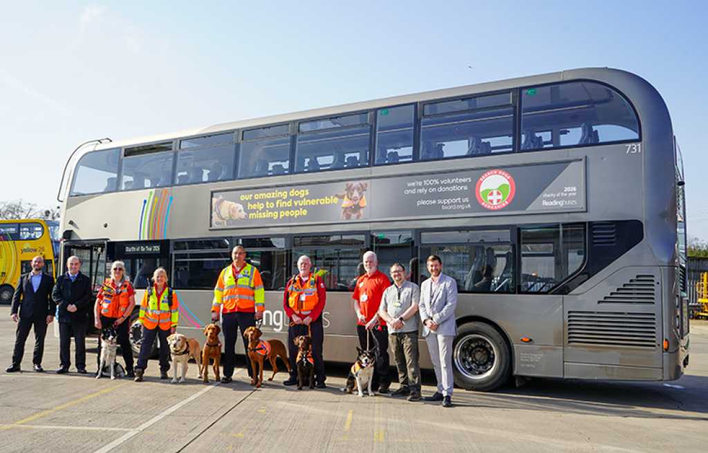 charity and dogs in front of a bus